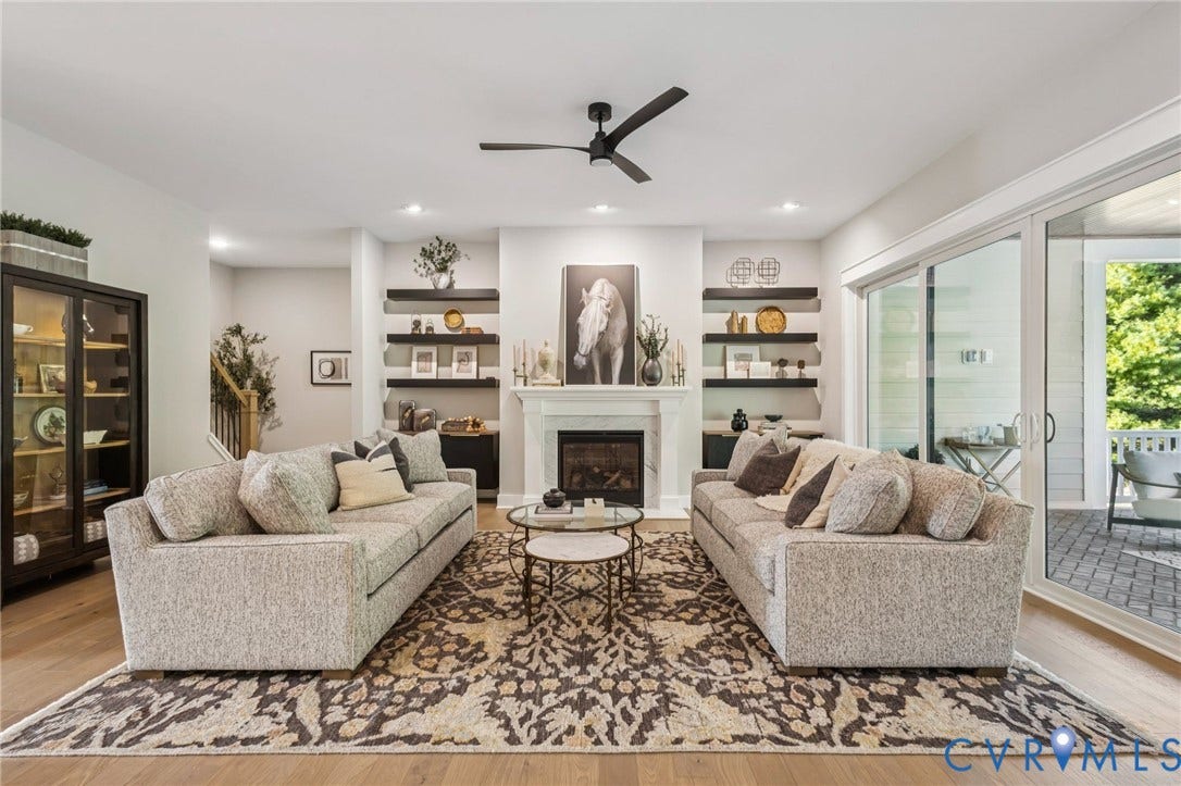 9275 Topeka Road, Quinton, VA 23141 Living area featuring a fireplace with a white mantel, built-in shelving, wood-finish flooring, recessed lighting, and sliding glass doors opening to an outdoor patio