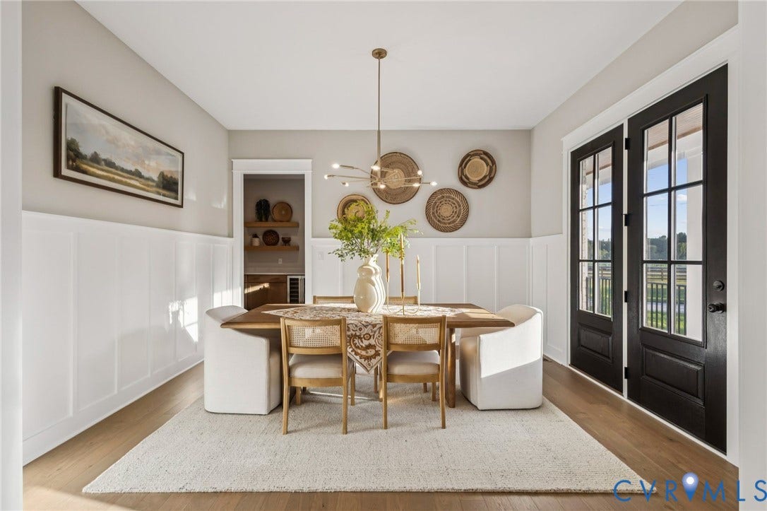 9275 Topeka Road, Quinton, VA 23141 Dining area featuring wood-finish flooring, white wainscoting, and a contemporary linear chandelier