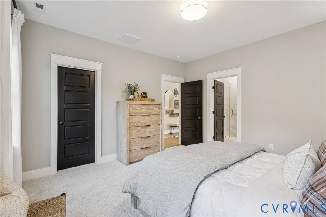 9275 Topeka Road, Quinton, VA 23141 Light-toned walls with contrasting dark paneled doors and white trim, featuring soft carpet flooring