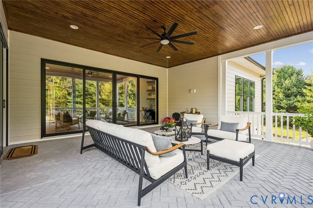 9275 Topeka Road, Quinton, VA 23141 Spacious covered patio featuring a wood-finish ceiling, ceiling fan, and herringbone-patterned flooring
