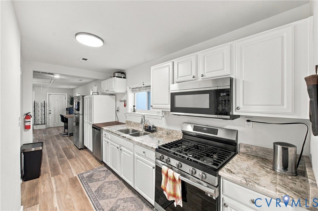 20 Victor Street, Geo Moss Estate, Hampton, VA 23669 Kitchen featuring white cabinetry, stone-patterned countertops, stainless steel gas range, stainless steel microwave, and wood-finish flooring