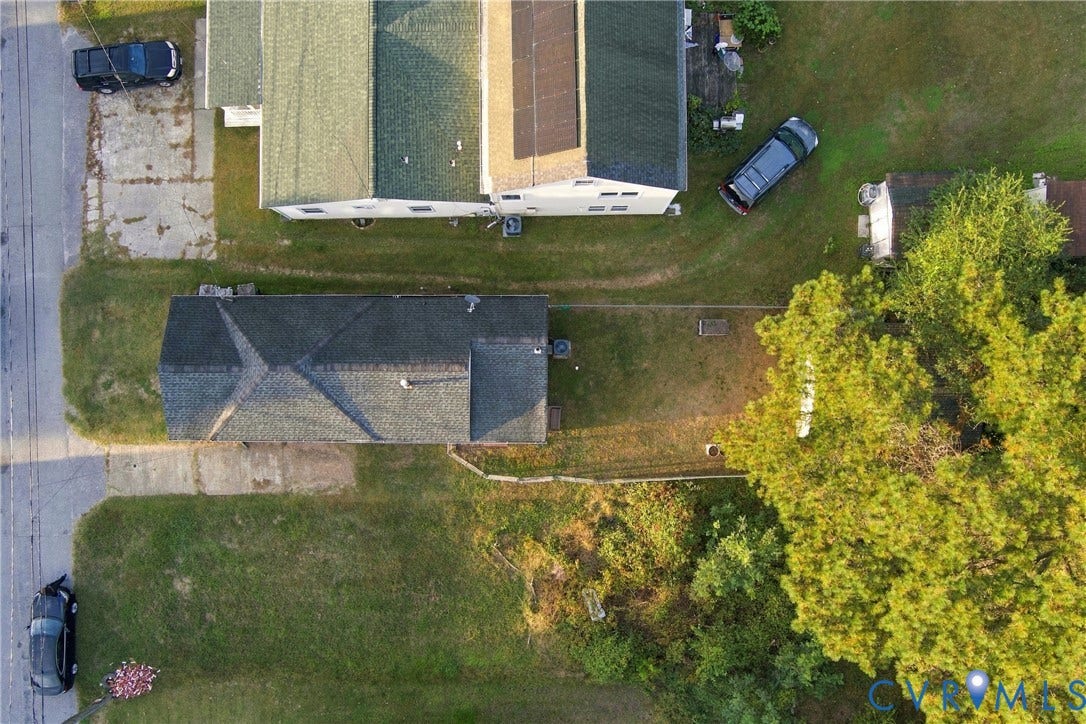 20 Victor Street, Geo Moss Estate, Hampton, VA 23669 Aerial perspective of a detached structure featuring a multi-pitched roof, shingle exterior, integrated solar panels, and an open-concept lot with mature landscaping
