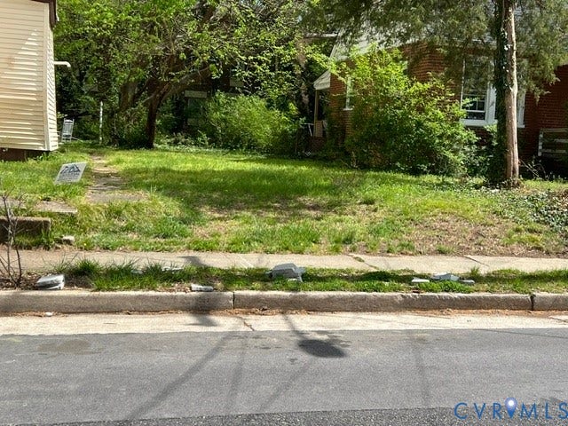 15 E 33RD Street, Richmond, VA 23225 Open lot featuring established trees, concrete curbing, and sidewalk access