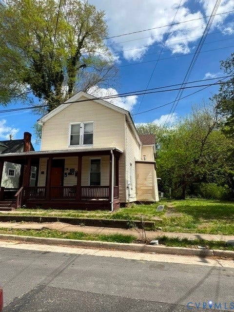 15 E 33RD Street, Richmond, VA 23225 Two-story residence featuring light-colored horizontal siding, a covered front porch with railings, and a concrete foundation