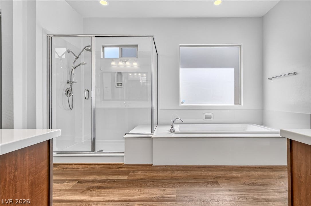 29 Porto Malaga Street, Henderson, NV 89011 Indulge in this bathroom featuring a large soaking tub and a sleek glass-enclosed shower.