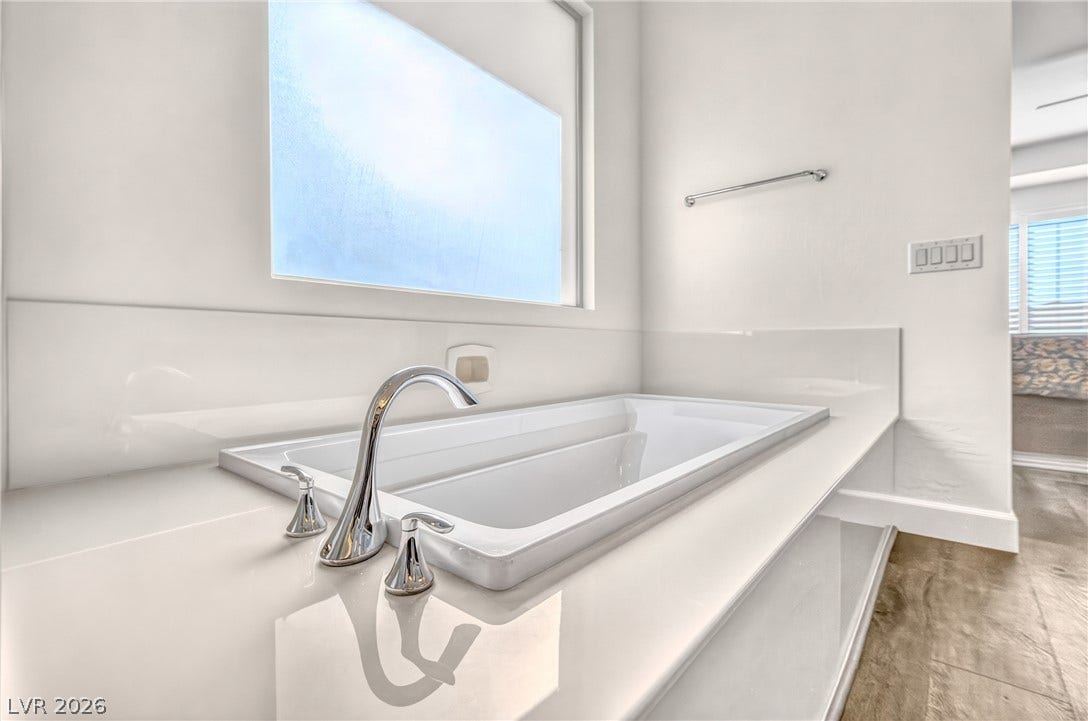 29 Porto Malaga Street, Henderson, NV 89011 Indulge in a tranquil bathing experience with this deep soaking tub, elegantly integrated into a polished countertop.
