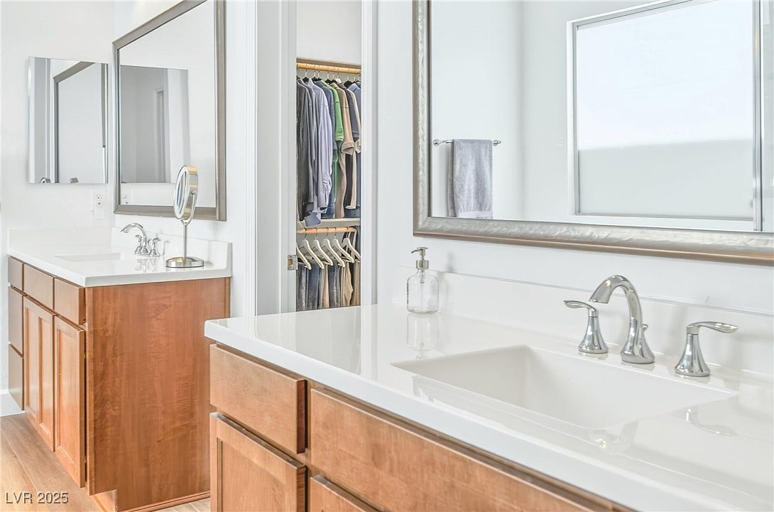 29 Porto Malaga Street, Henderson, NV 89011 A bright and inviting primary bathroom with a functional dual vanity and a relaxing atmosphere designed for everyday comfort.