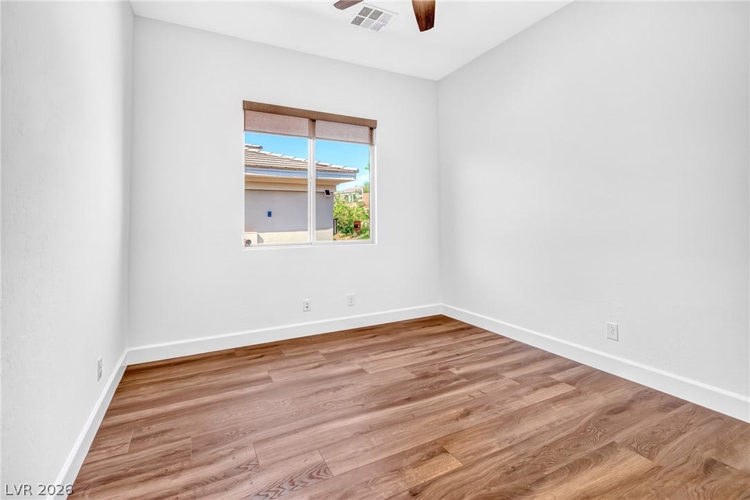 29 Porto Malaga Street, Henderson, NV 89011 Bright, naturally illuminated bedroom with resilient wood flooring and overhead ceiling fan for optimal air circulation.