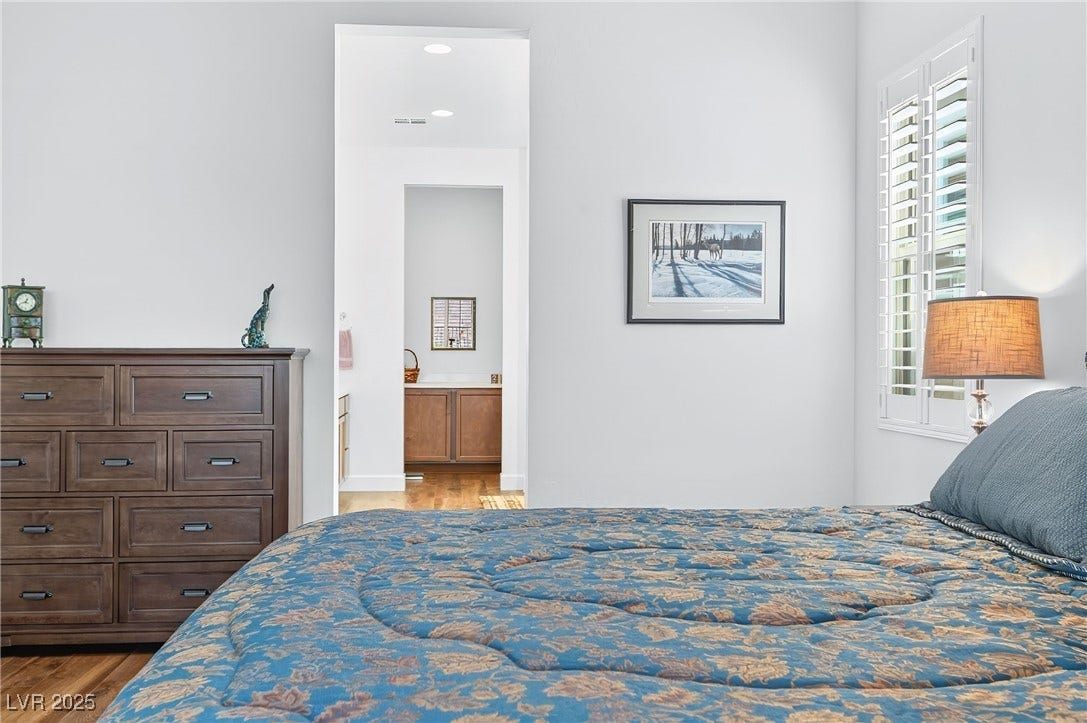 29 Porto Malaga Street, Henderson, NV 89011 A spacious primary suite designed for comfort and relaxation, featuring ample natural light and a peaceful atmosphere to unwind.