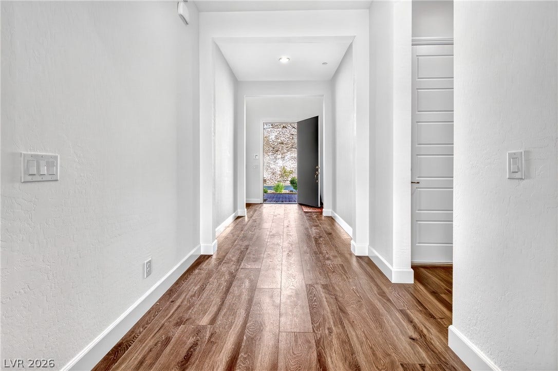 29 Porto Malaga Street, Henderson, NV 89011 A well-lit entry hall with wood flooring ushers you into the home.