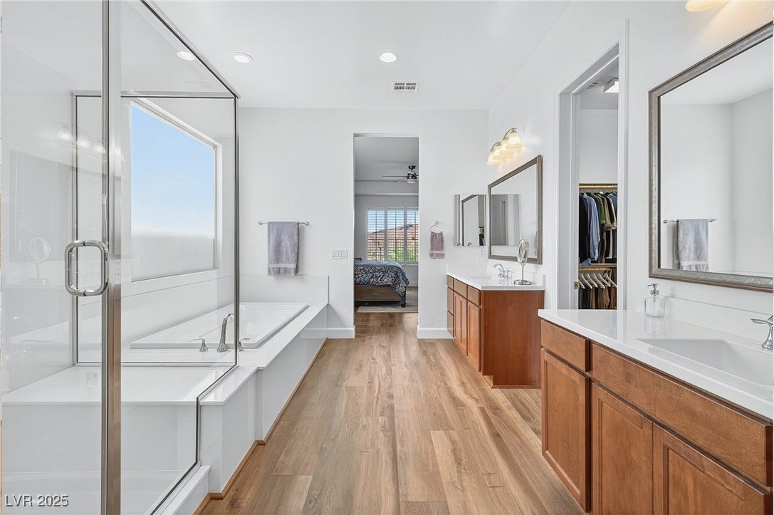 29 Porto Malaga Street, Henderson, NV 89011 The primary bathroom offers a spacious layout with modern fixtures, a dual sink vanity, and a clean, timeless design.