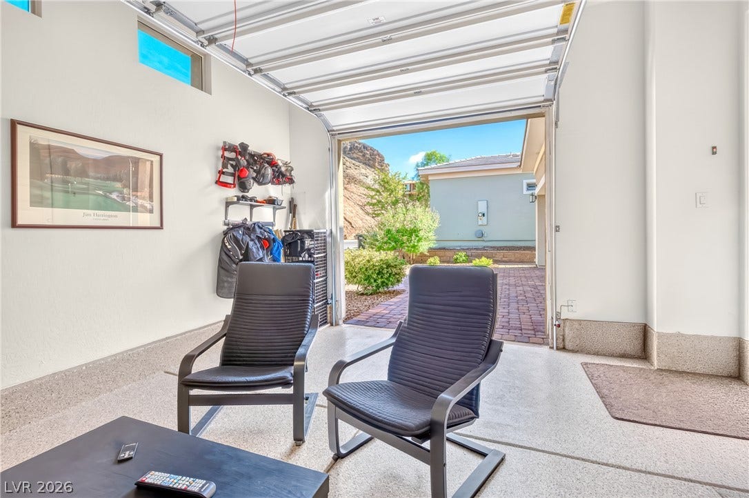 29 Porto Malaga Street, Henderson, NV 89011 A versatile garage space offers a seamless transition to the outdoors, perfect for leisure or projects.