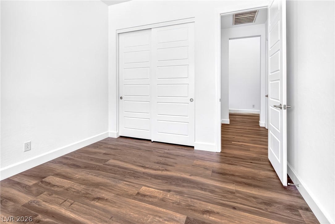 29 Porto Malaga Street, Henderson, NV 89011 Rich hardwood-style flooring extends across this bright, versatile space, complete with a convenient sliding closet.