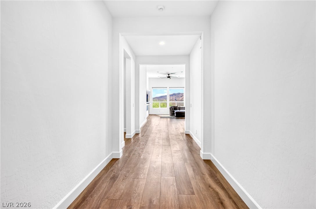 29 Porto Malaga Street, Henderson, NV 89011 A welcoming hall leads to a living space framed by views of the distant mountains.