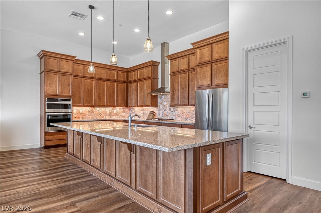 29 Porto Malaga Street, Henderson, NV 89011 A grand central island provides ample preparation space in this well-appointed kitchen.