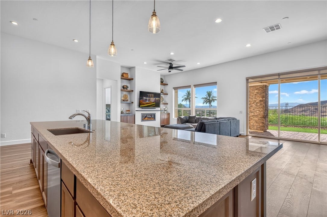 29 Porto Malaga Street, Henderson, NV 89011 A sprawling granite island anchors this open-concept living space with hillside views.