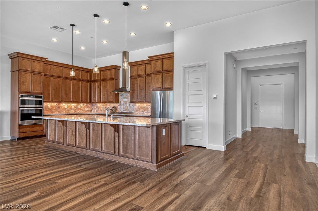 29 Porto Malaga Street, Henderson, NV 89011 Culinary dreams come alive in this kitchen, featuring custom cabinetry and sleek, built-in appliances.