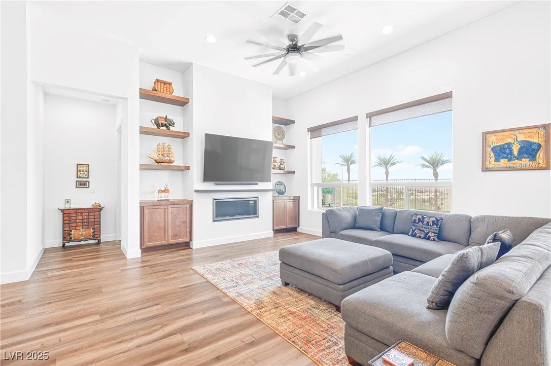 29 Porto Malaga Street, Henderson, NV 89011 The living room offers a warm and inviting space with an open layout, ideal for relaxing or entertaining, and filled with natural light.