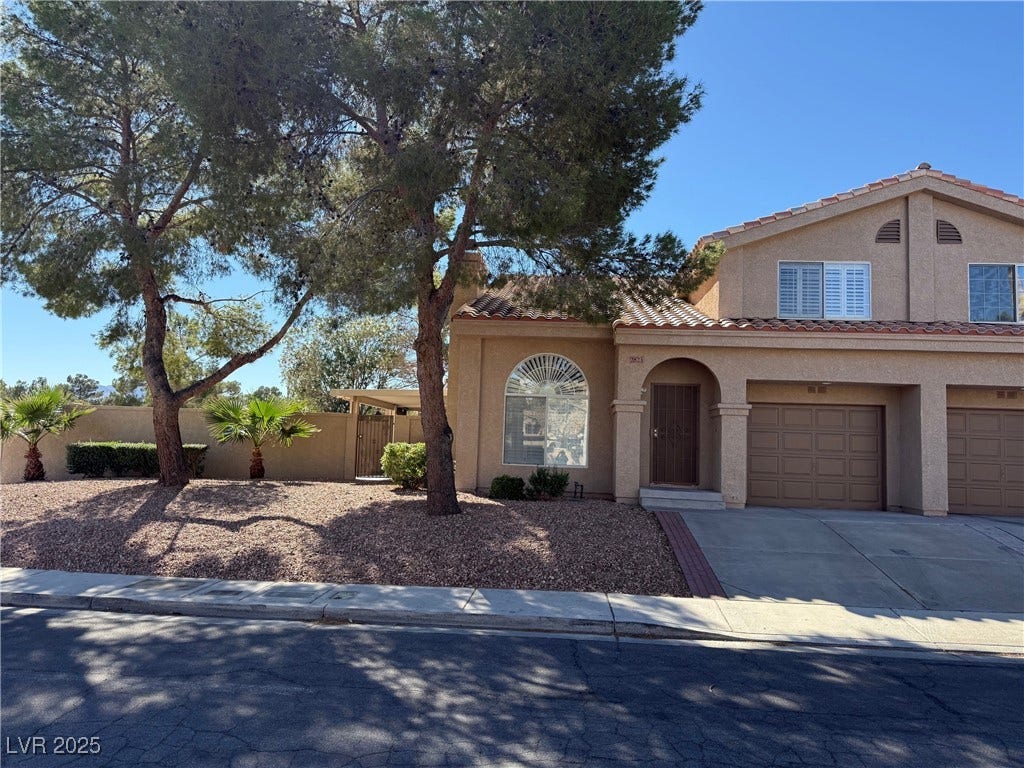 2823 Shannon Cove Drive, Henderson, NV 89074 Mediterranean / spanish home featuring stucco siding, driveway, an attached garage, and a tiled roof
