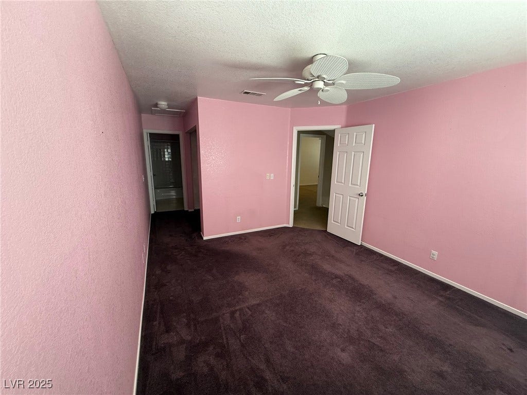 2823 Shannon Cove Drive, Henderson, NV 89074 Unfurnished bedroom with dark colored carpet, a ceiling fan, and a textured ceiling