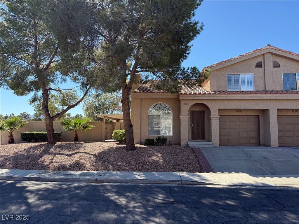 2823 Shannon Cove Drive, Henderson, NV 89074 Mediterranean / spanish home featuring stucco siding, a garage, driveway, and a tile roof
