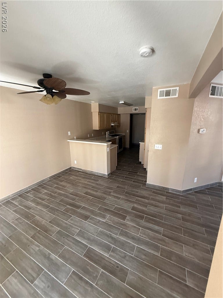 2823 Shannon Cove Drive, Henderson, NV 89074 An open living space transitions seamlessly into the kitchen over modern tile plank flooring.