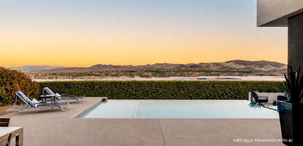 An inviting pool area offers relaxation with captivating mountain and water views.