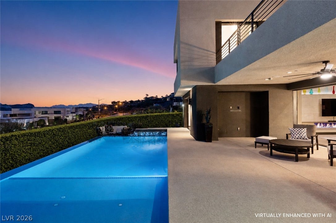 This modern outdoor living area features a refreshing pool and an inviting patio with a view.