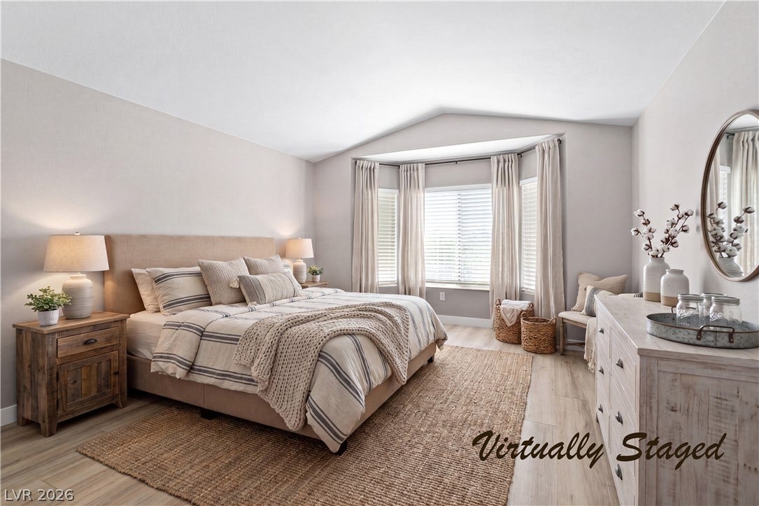 2154 High Mesa Drive, Henderson, NV 89012 A well-lit bedroom features a unique bay window, offering an inviting space for rest and rejuvenation.