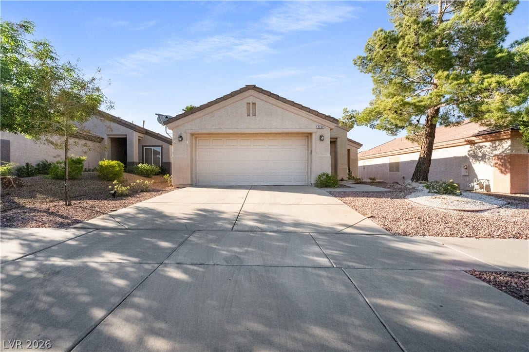 2154 High Mesa Drive, Henderson, NV 89012 This residence features a sturdy concrete driveway leading to an attached garage, blending convenience with curb appeal.