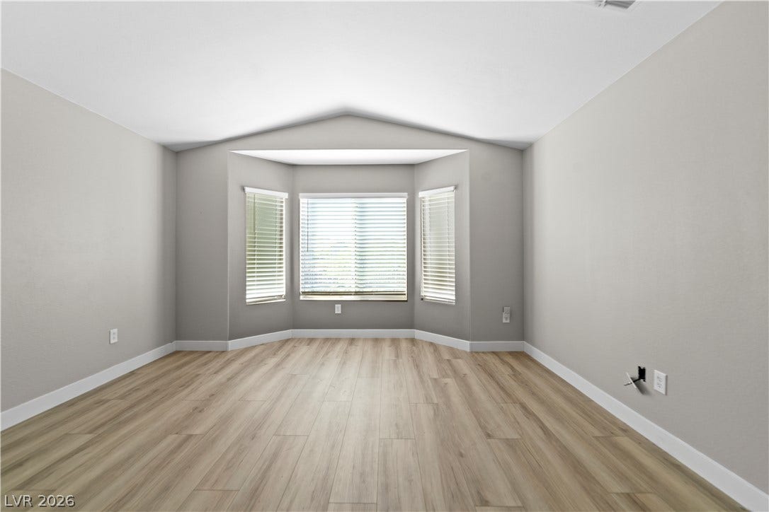 2154 High Mesa Drive, Henderson, NV 89012 A well-lit room with bay windows offers a versatile space for living or dining.