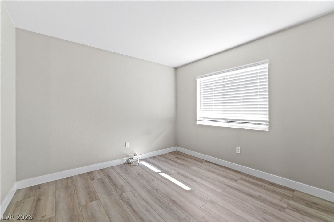 2154 High Mesa Drive, Henderson, NV 89012 A quiet, naturally illuminated room featuring durable hardwood flooring and crisp white trim.