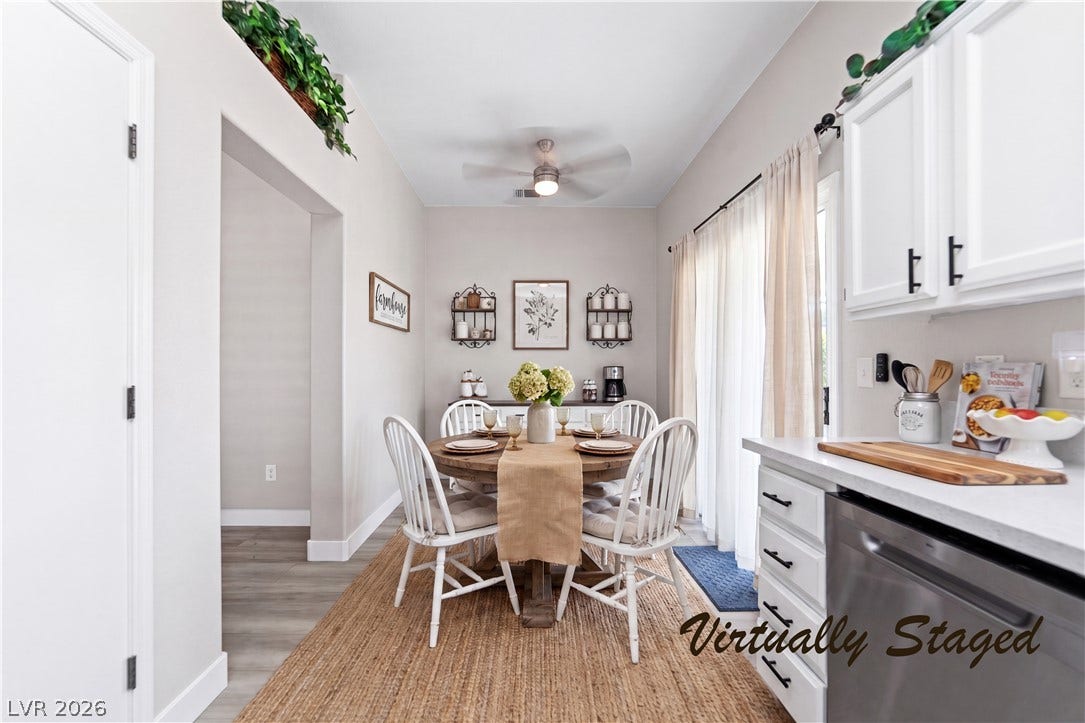 2154 High Mesa Drive, Henderson, NV 89012 A charming dining area features a round wooden table, seating for four, and convenient access to the kitchen and outdoors.