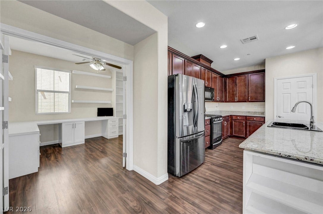 3086 Ripe Peak Lane, Henderson, NV 89044 This versatile space features a well-appointed kitchen and an adjacent office, perfect for modern living.