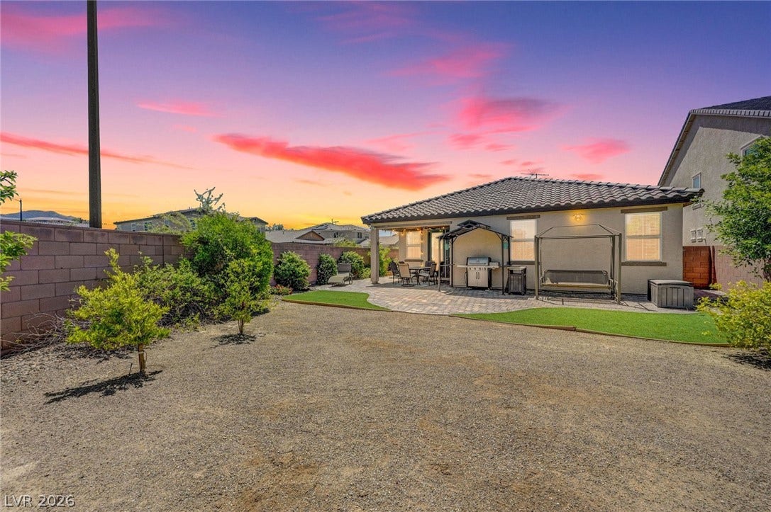 3086 Ripe Peak Lane, Henderson, NV 89044 Enjoy evening entertaining with an outdoor kitchen, covered patio, and ample yard space.