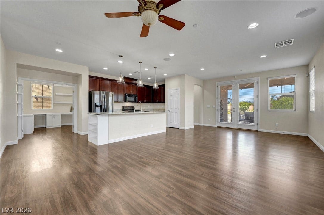 3086 Ripe Peak Lane, Henderson, NV 89044 Bright and airy living area with modern kitchen and hardwood floors.