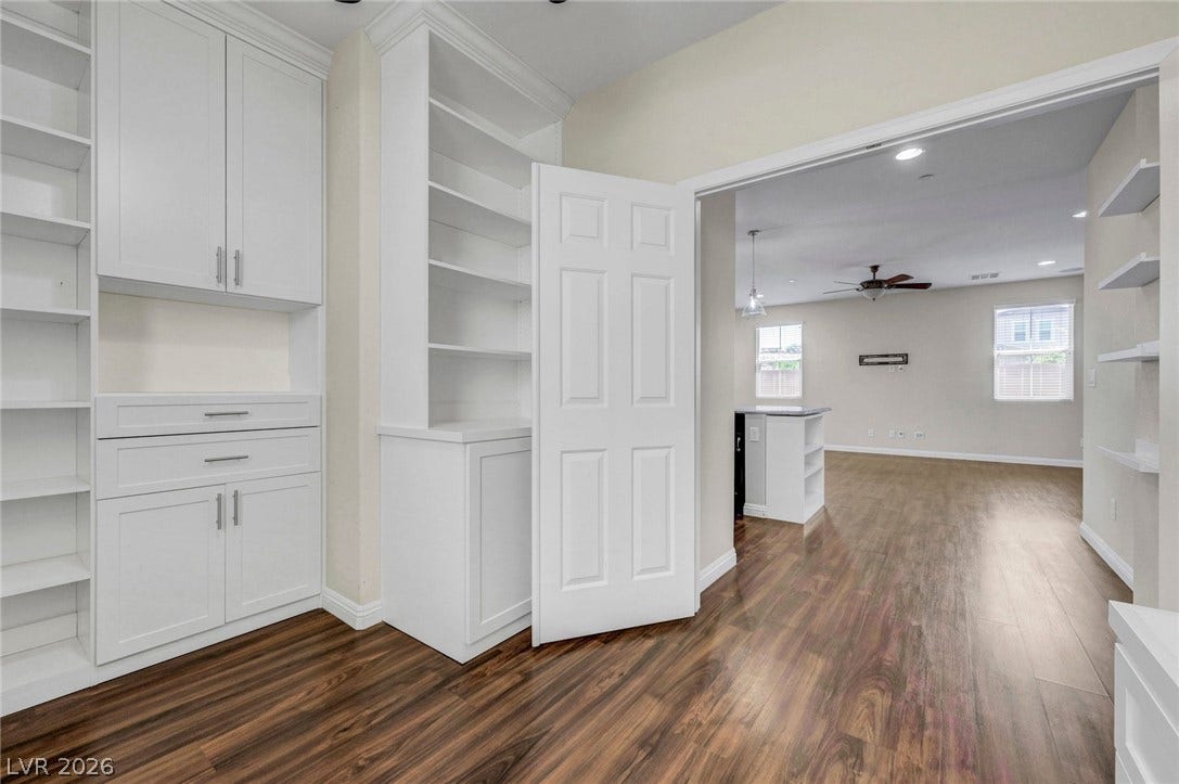 3086 Ripe Peak Lane, Henderson, NV 89044 This versatile space features built-in shelving, rich hardwood flooring, and an inviting open floorplan.