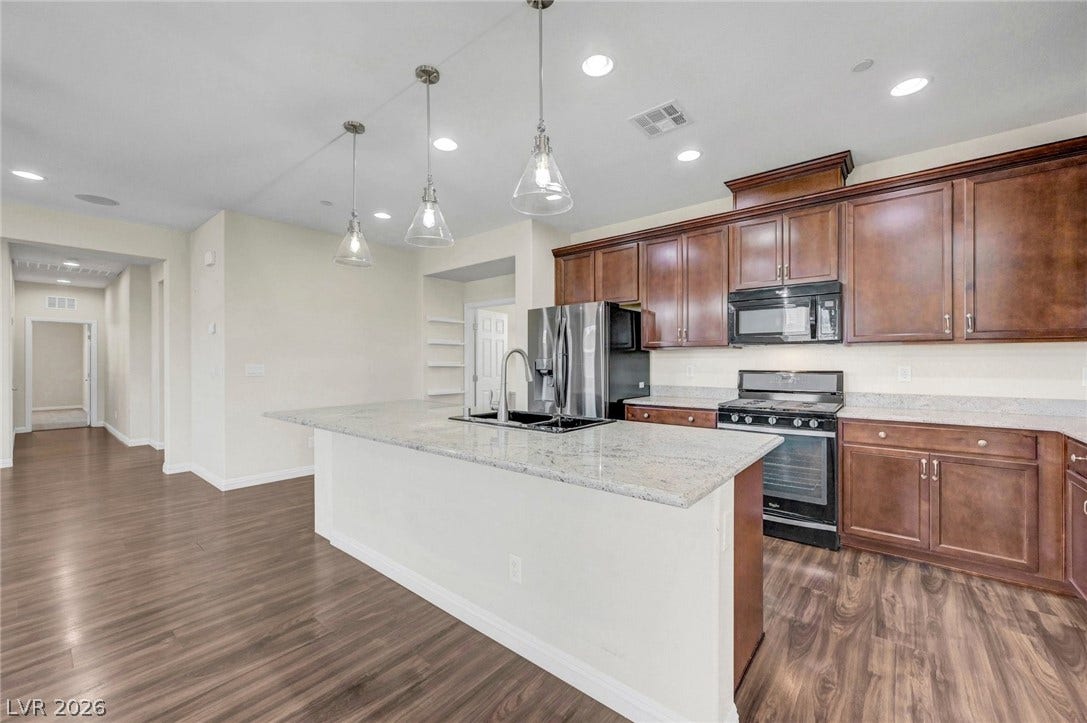 3086 Ripe Peak Lane, Henderson, NV 89044 This spacious kitchen offers a large island with ample counter space and modern appliances.