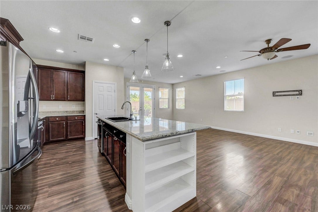 3086 Ripe Peak Lane, Henderson, NV 89044 An inviting open-concept kitchen and living area features gleaming hardwood floors and ample natural light.