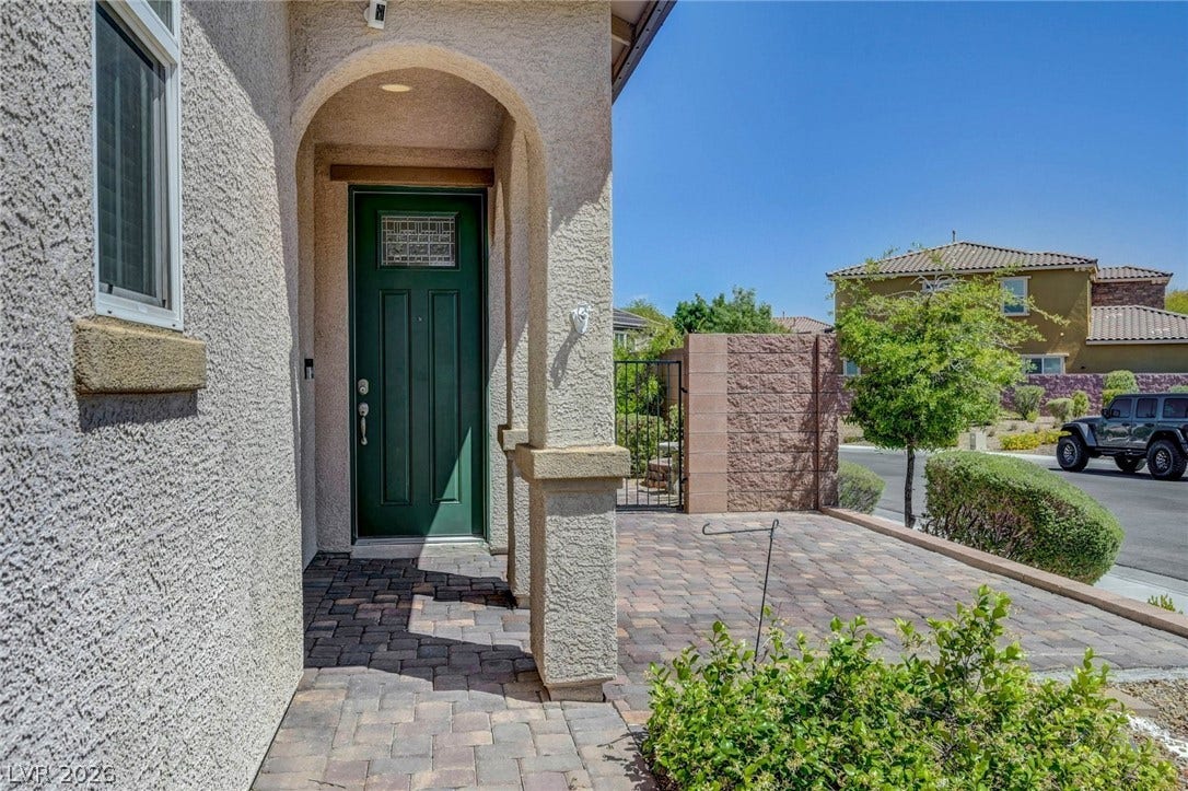3086 Ripe Peak Lane, Henderson, NV 89044 Enter this home through a charming arched entryway.