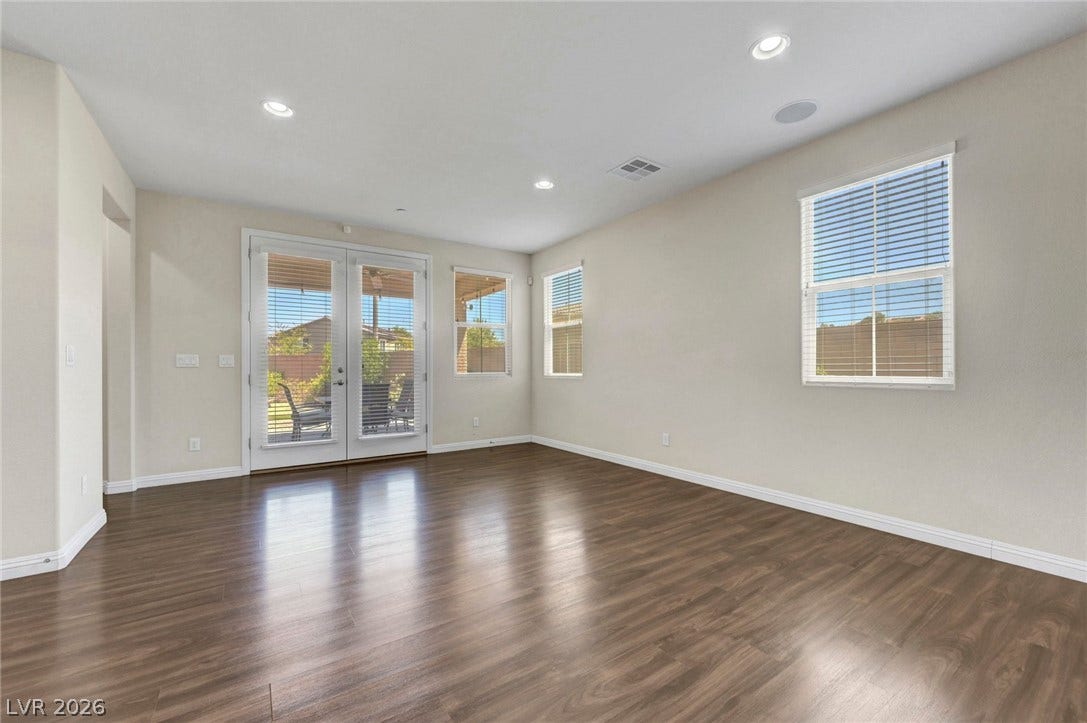 3086 Ripe Peak Lane, Henderson, NV 89044 Bright and airy living area with rich wood flooring and ample natural light.