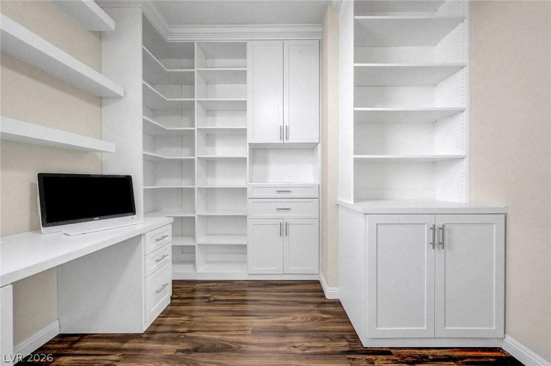 3086 Ripe Peak Lane, Henderson, NV 89044 This versatile home office features extensive built-in shelving and a dedicated workspace.