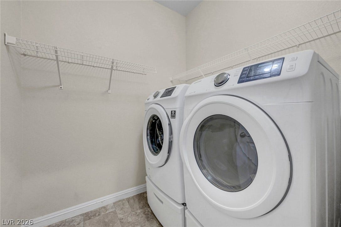 3086 Ripe Peak Lane, Henderson, NV 89044 This dedicated laundry space offers practical utility with modern appliances and convenient storage.