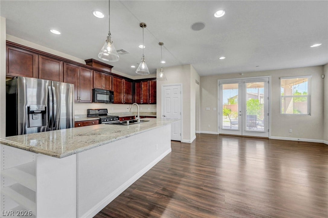 3086 Ripe Peak Lane, Henderson, NV 89044 This spacious kitchen and living area features gleaming wood floors and ample natural light.