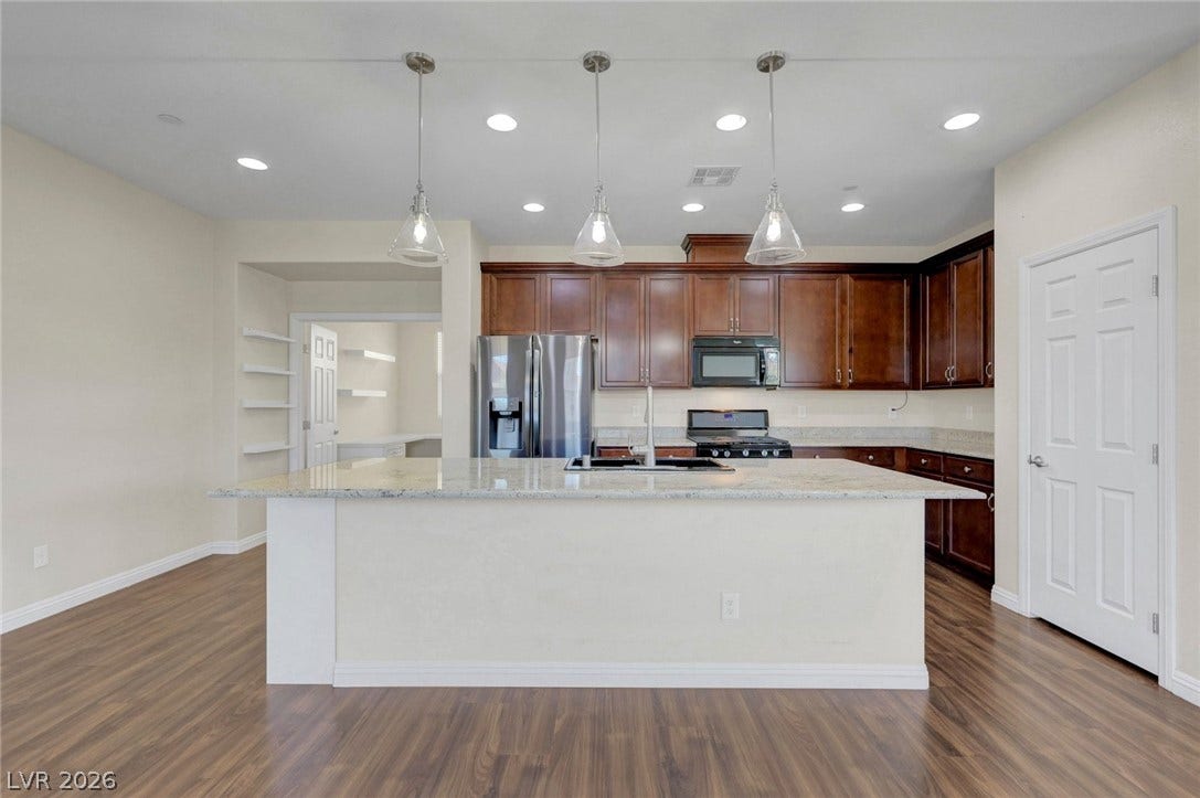 3086 Ripe Peak Lane, Henderson, NV 89044 An inviting kitchen with rich cabinetry and ample counter space awaits culinary adventures.