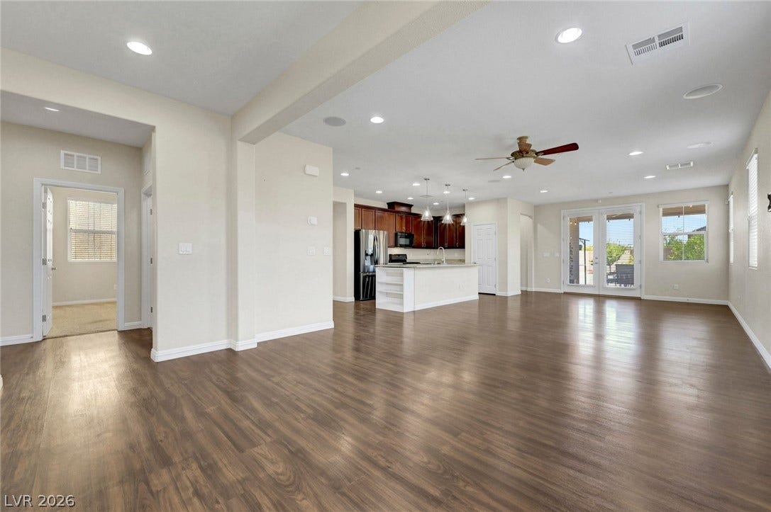 3086 Ripe Peak Lane, Henderson, NV 89044 This expansive open-concept living area seamlessly connects the kitchen to the outdoors, perfect for entertaining.