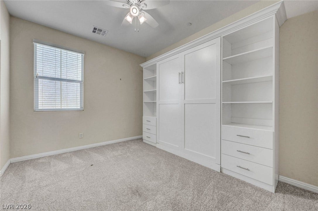 3086 Ripe Peak Lane, Henderson, NV 89044 This versatile room features built-in storage solutions and a functional ceiling fan for comfort.