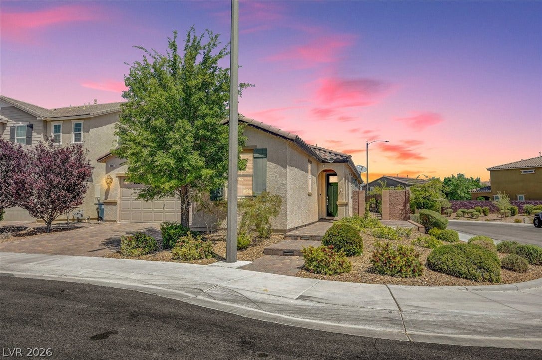 3086 Ripe Peak Lane, Henderson, NV 89044 This charming home features a stucco exterior and well-maintained landscaping, all under a vibrant sky.