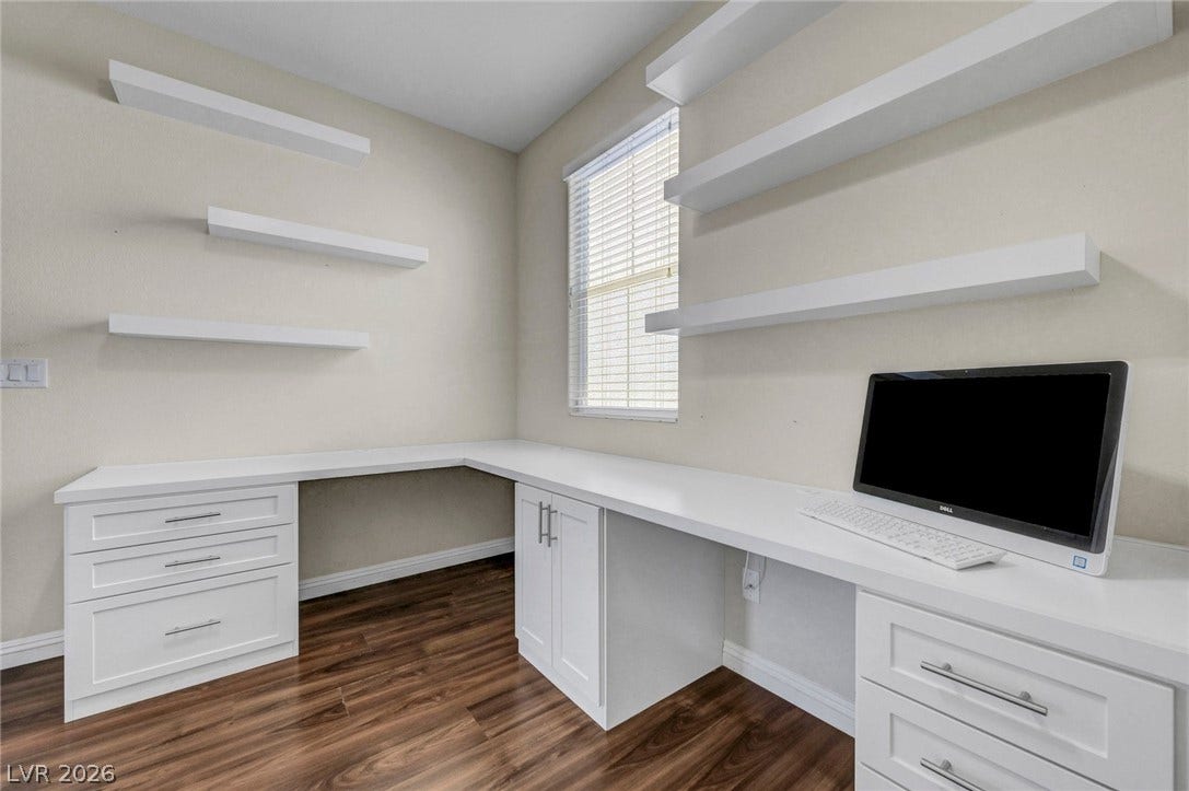 3086 Ripe Peak Lane, Henderson, NV 89044 This dedicated office space features built-in desks and shelving, perfect for productivity.