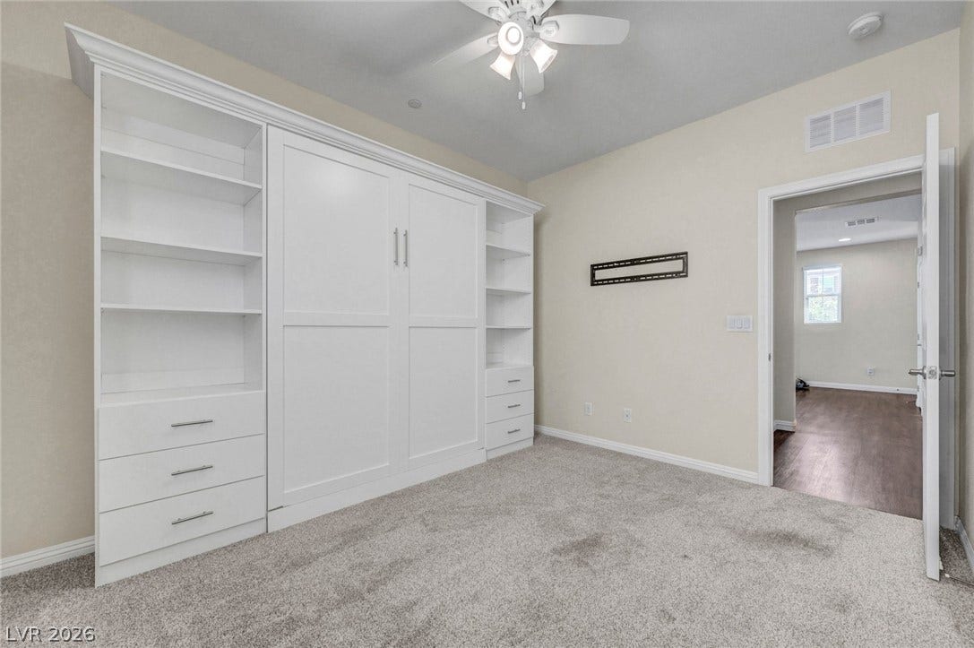 3086 Ripe Peak Lane, Henderson, NV 89044 This versatile room features custom built-ins and soft carpeting, ideal for flexible living.